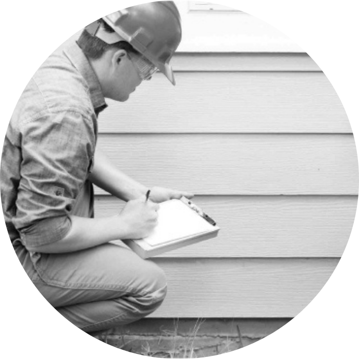 A man performing a house exterior inspection while holding a checklist, representing CDC Granny Flat requirements and compliance checks.