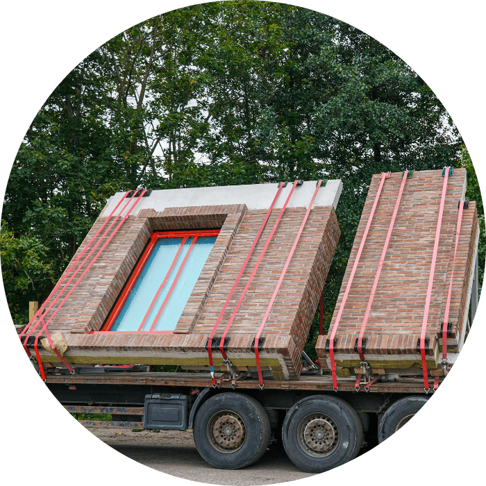 A truck unloading pre made walls for a granny flat, representing construction of custom built granny flats.