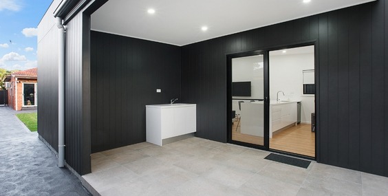 A modern secondary dwelling features a high-end internal kitchen and an integrated outdoor sink, highlighting the premium amenities that drive a successful Granny Flat Investment.