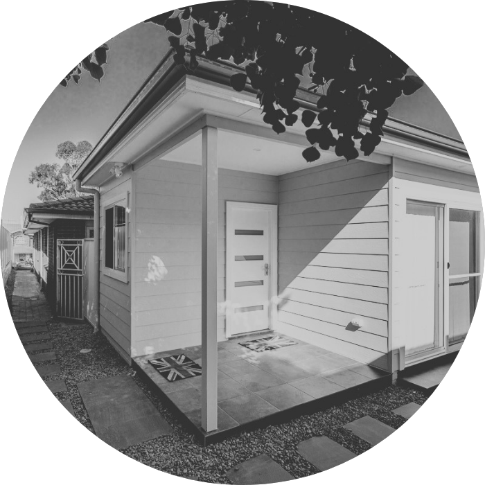 A small dwelling with a covered entryway and modern door, representing the quality and design of premium granny flats.