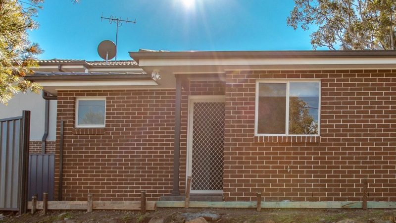 A premium two-bedroom secondary dwelling with a durable brick-veneer exterior stands as a high-yield Granny Flat Investment in a suburban Sydney backyard.
